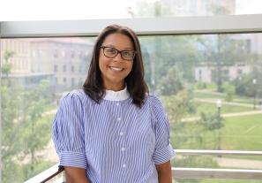 Photos of Ashley Felix smiling with Thompson Library int he background.